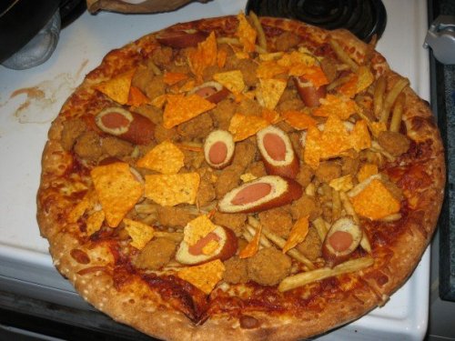 Snack Pizza Bomb Pizza topped with french fries, sliced corn dogs, popcorn chicken and Doritos. (submitted by Mike)